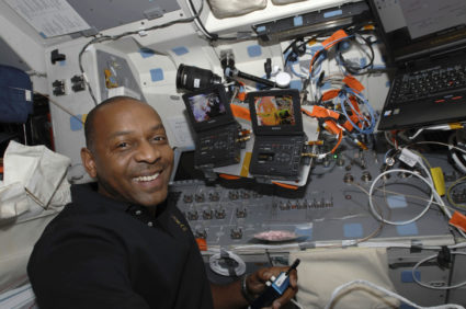 Astronaut Robert L. Satcher Jr. appears to be enjoying his duties on the aft flight deck of the Space Shuttle Atlantis.