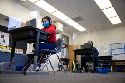 A student uses a computer from a socially-distanced desk during an in-person hybrid learning day at the Mount Vernon Community School in Alexandria, Virginia, U.S., March 2, 2021. Photo by Tom Brenner/REUTERS