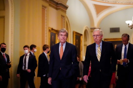 U.S. Senate Minority Leader Mitch McConnell and Senator Roy Blunt walk through the hallway at the U.S. Capitol in Washington