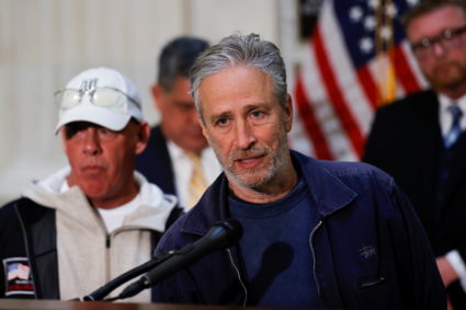 Jon Stewart, with activist John Feal, speaks to reporters about their effort to raise awareness for U.S. veterans sufferin...
