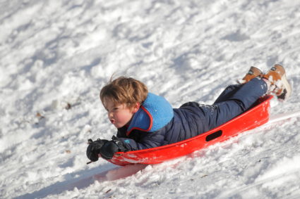 A child uses a sled following a snow storm in Brooklyn, New York