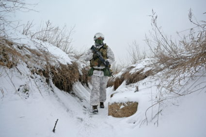A service member of the Ukrainian armed forces walks at combat positions in Donetsk Region