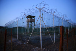 Chain link fence and concertina wire surrounds a deserted guard tower within Joint Task Force Guantanamo's Camp Delta at t...