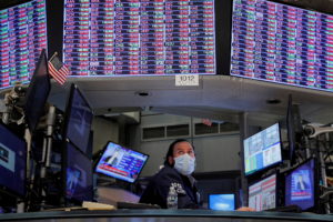 FILE PHOTO: Traders work on the floor of the NYSE in New York City