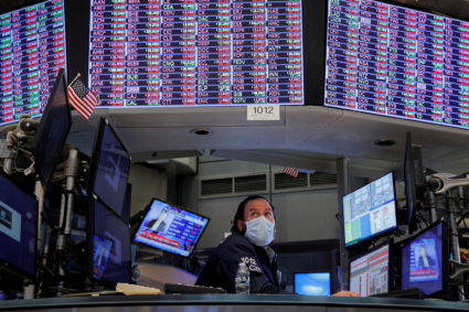 FILE PHOTO: Traders work on the floor of the NYSE in New York City