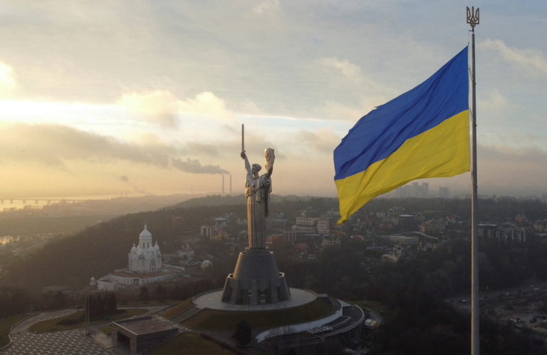 Ukraine's biggest national flag on the country's highest flagpole and the giant 'Motherland' monument are seen at a compou...