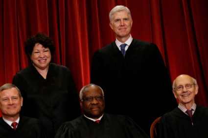 FILE PHOTO: Gorsuch smiles as he joins his fellow justices for a new U.S. Supreme Court family photo including him, their ...