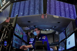 FILE PHOTO: Traders work on the floor of the NYSE in New York