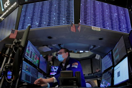FILE PHOTO: Traders work on the floor of the NYSE in New York