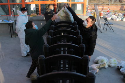Worker delivers food supplies to residents at a residential compound under lockdown following the COVID-19 outbreak in Xian