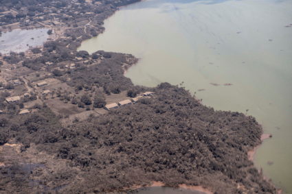 A general view from a New Zealand Defence Force P-3K2 Orion surveillance flight shows ash covered homes and vegetation ove...