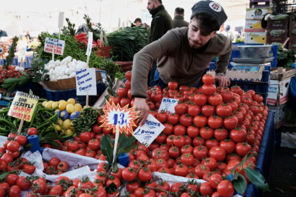 A vendor waits for customers at his stall in a street market in Istanbul