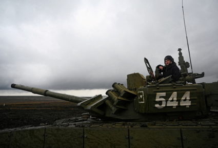 FILE PHOTO: A Russian service member is seen atop a T-72B3 main battle tank during military drills at the Kadamovsky range...