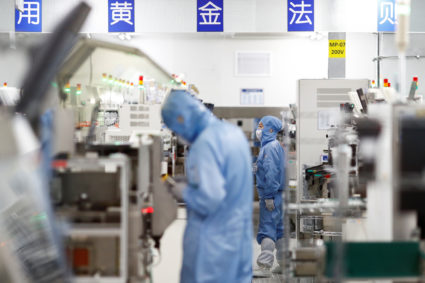 Employees work at a factory of Renesas Semiconductor Co. during a government organised tour of the facility following the outbreak of the coronavirus disease (COVID-19), in Beijing, China May 14, 2020. Photo by Thomas Peter/REUTERS