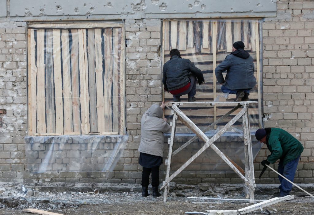 People carry out repair works in a school in Donetsk