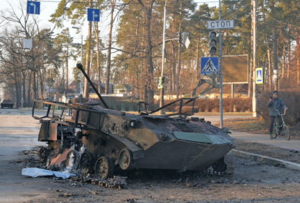 A charred armoured vehicle is seen on a street in Bucha