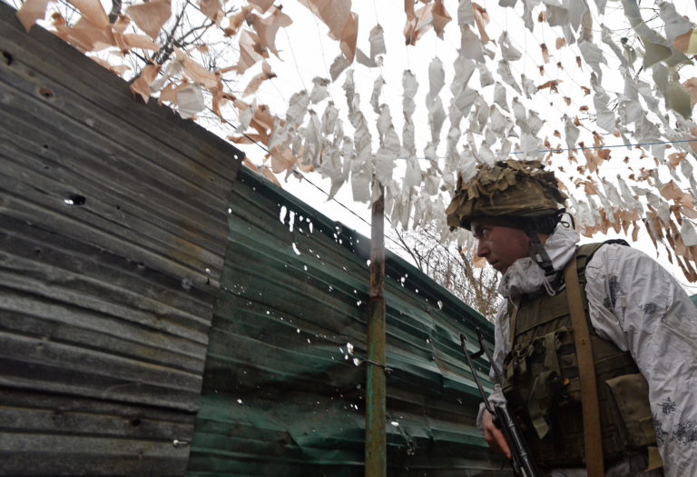Ukrainian service members guard the area near the line of separation in the Donetsk Region