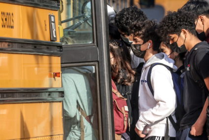Students board a school bus outside of Washington-Liberty High School in Arlington County which is one of several school districts which sued to stop the mask-optional order by Governor Glenn Youngkin (R), in Arlington, Virginia, U.S., January 25, 2022. Photo by Evelyn Hockstein/REUTERS