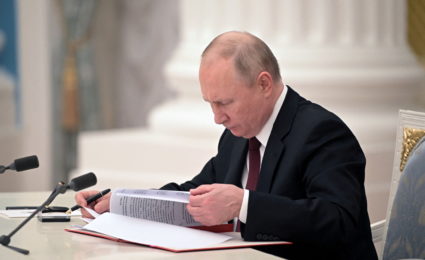 Russian President Vladimir Putin signs documents, including a decree recognising two Russian-backed breakaway regions in eastern Ukraine as independent entities, during a ceremony in Moscow, Russia, in this picture released February 21, 2022. Photo by Sputnik/Alexey Nikolsky/Kremlin via REUTERS