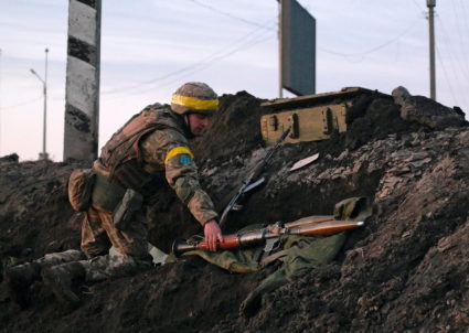 A Ukrainian serviceman holds a rocket-propelled grenade launcher at fighting positions outside Kharkiv
