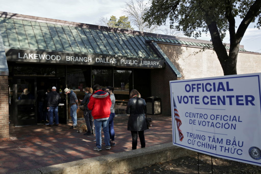 People line up to vote in the primary election at the Lakewood Branch Library in Dallas, U.S., March 1, 2022. Photo by She...