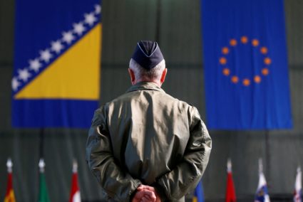 FILE PHOTO: Member of European Forces (EUFOR) stands in front of the Bosnia and Herzegovina and EU flags during Change of ...