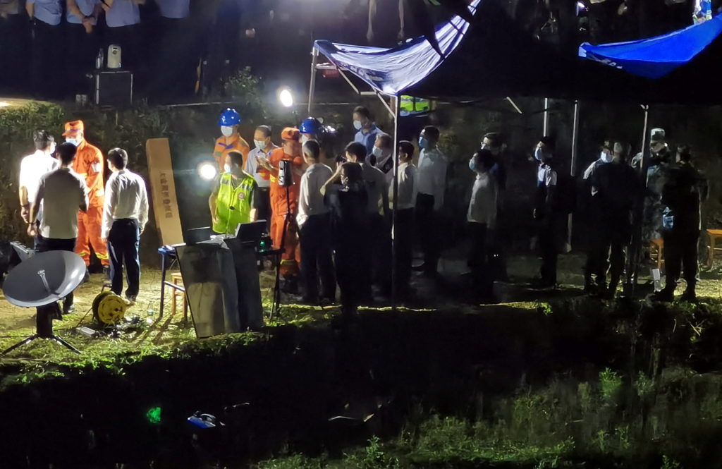 Rescue members work at the site where a China Eastern Airlines plane crashed in Wuzhou