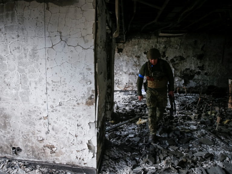 A Ukrainian service member walks on the front line near Kyiv