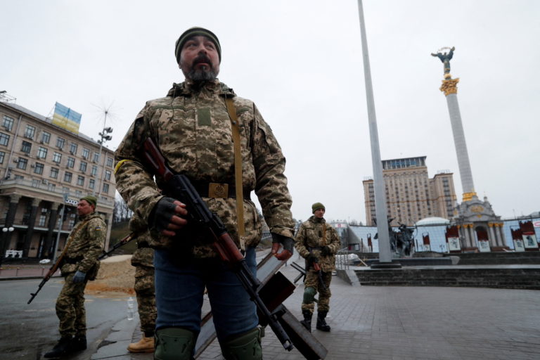 Members of the Territorial Defence Forces guard a checkpoint in central Kyiv