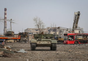 Service members of pro-Russian troops look on as they ride an armoured vehicle during fighting in Ukraine-Russia conflict ...