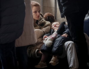 People wait to board an evacuation train at Kyiv central train station