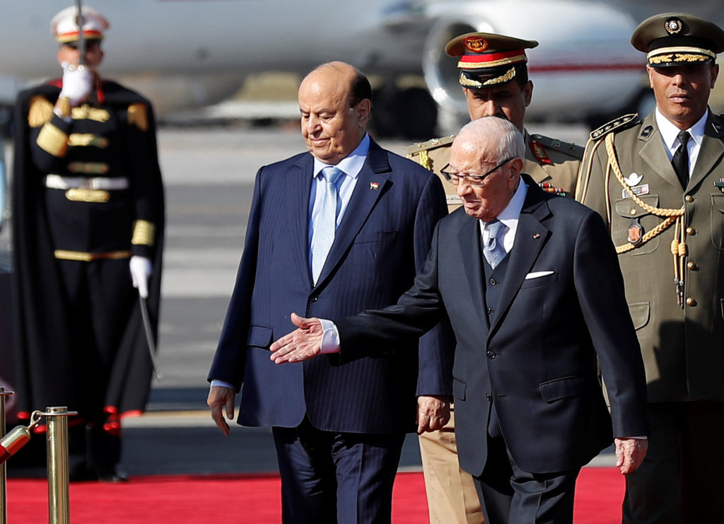 Yemen's President Abed Rabbo Mansour Hadi, left, walks next to his Tunisian counterpart Beji Caid Essebsi as they review a...