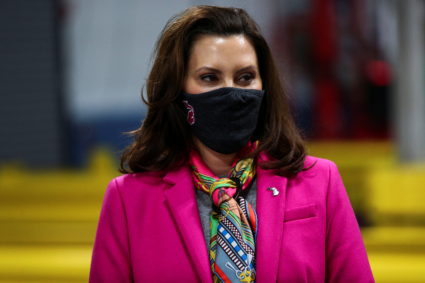 Michigan Governor Gretchen Whitmer folllows along as U.S. President Joe Biden tours a Pfizer manufacturing plant producing the coronavirus disease (COVID-19) vaccine in Kalamazoo, Michigan, U.S., February 19, 2021. Photo by Tom Brenner /REUTERS