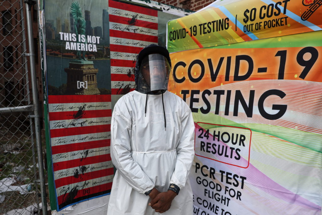 Kevon Jaskin, a health care administer, stands for a photograph by a mobile coronavirus disease (COVID-19) testing center ...