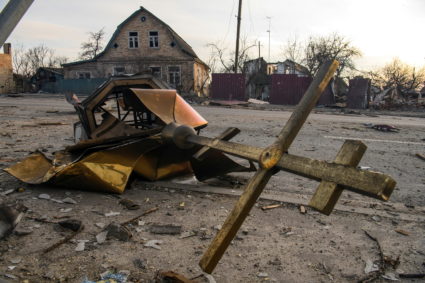 A cross and a destroyed dome of a local church damaged by shelling are seen on a road, as Russia's attack on Ukraine continues, in the settlement of Hostomel, outside Kyiv, Ukraine April 6, 2022. Photo by Vladyslav Musiienko/REUTERS