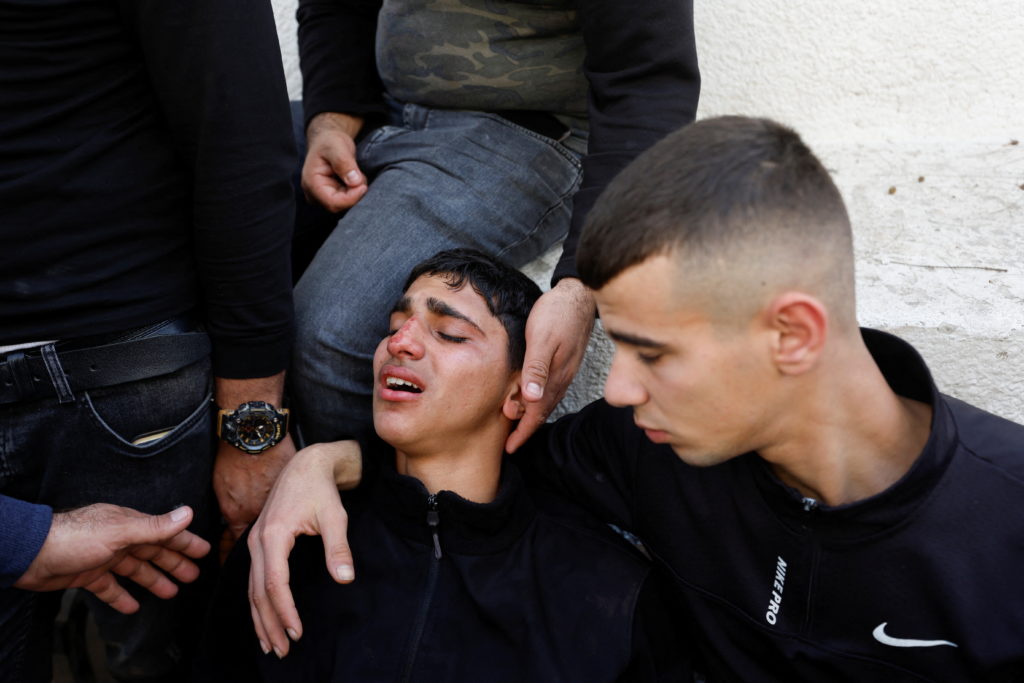 Israeli forces take position during a raid, in Jenin