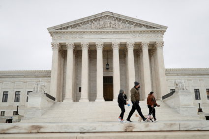 FILE PHOTO: Visitors walk along Supreme Court Plaza on Capitol Hill in Washington