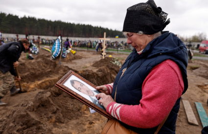 People mourn at the cemetery in Bucha
