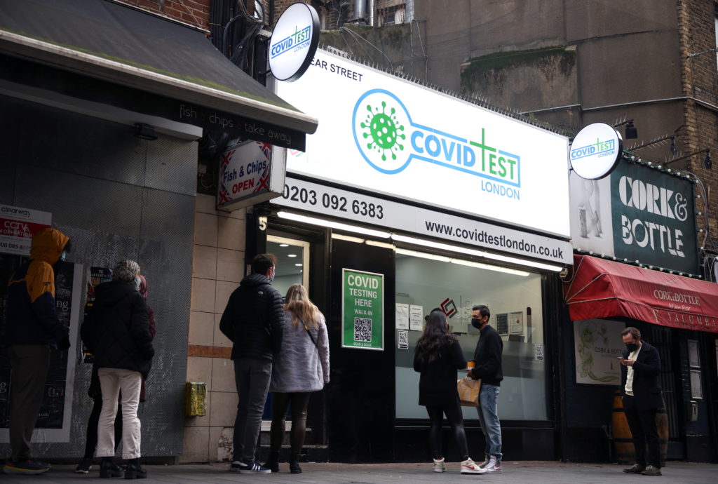 People queue outside a private coronavirus disease (COVID-19) testing facility, amid the COVID-19 outbreak, in central London