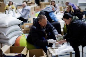 Ukrainian volunteers prepare to deliver food inside a complex, set up as a shelter, amid Russia's invasion of Ukraine, in ...