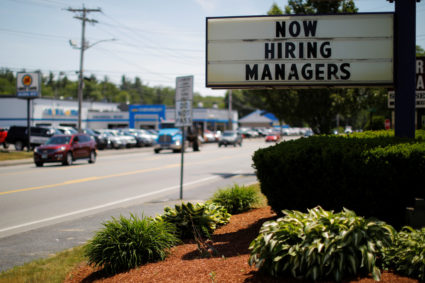 The sign on a Taco Bell restaurant advertises "Now Hiring Managers" in Fitchburg