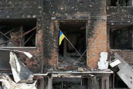 A Ukrainian national flag is seen in an apartment of a residential building damaged during Russia’s invasion of Ukraine in...