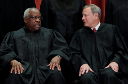 U.S. Supreme Court justices pose for group portrait at the Supreme Court in Washington