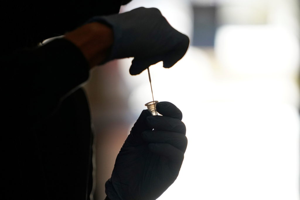 A healthcare worker processes a rapid coronavirus disease (COVID-19) test at the Tower Theatre in Oklahoma City