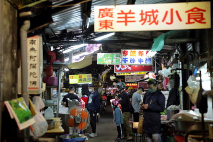 People wait at a food stall in Taipei