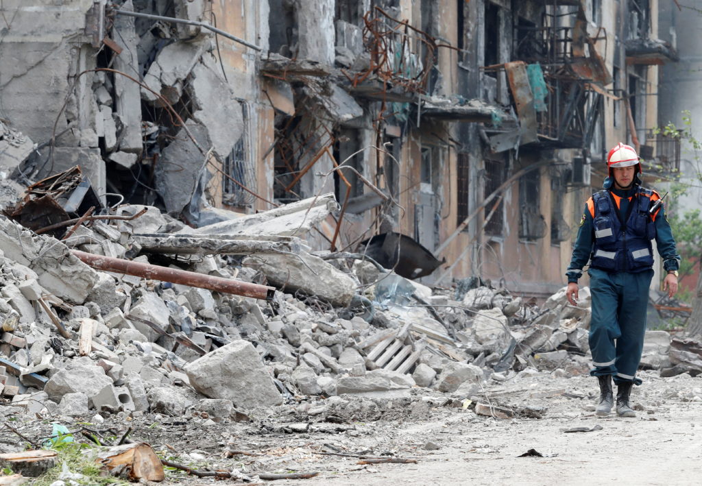 Rescuers remove debris of a destroyed residential building in Mariupol