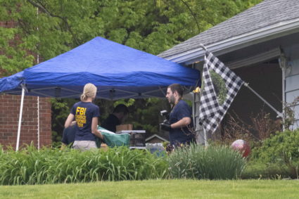 Law enforcement personnel are seen at the home of Buffalo supermarket shooting suspect