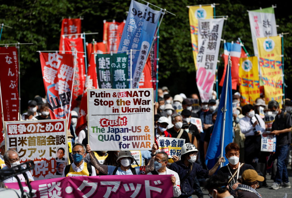 Protesters march against the talks between the U.S. President Biden and Japan's Prime Minister Kishida and Quad summit, in...