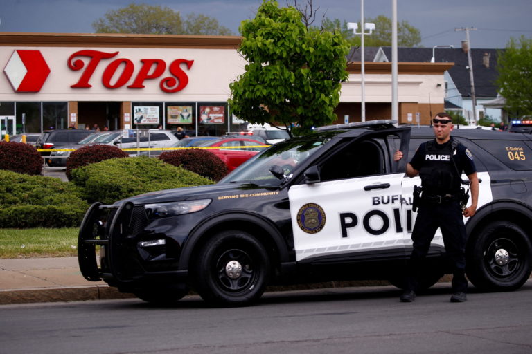 Police officers secure the scene after a shooting at TOPS supermarket in Buffalo