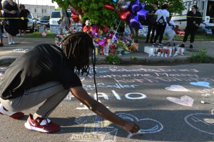 People leave messages at a makeshift memorial near a Tops Grocery store in Buffalo, New York, on May 15, 2022, the day after a gunman shot 10 people. Photo by USMAN KHAN/AFP via Getty Images